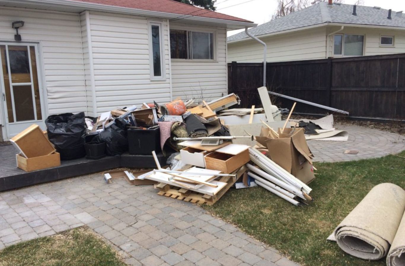 A BE&P Services professional providing expert junk removal in Aspen Woods, AB, ensuring a clean and tidy environment.